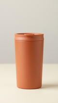 A Nature's Companion tumbler in Terracotta is dead center in the frame, photographed with a 50mm lens for a clean,...