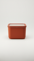 A straight-on, perfectly centered shot of a stackable food storage container, with its sleek, minimalist design showcased...