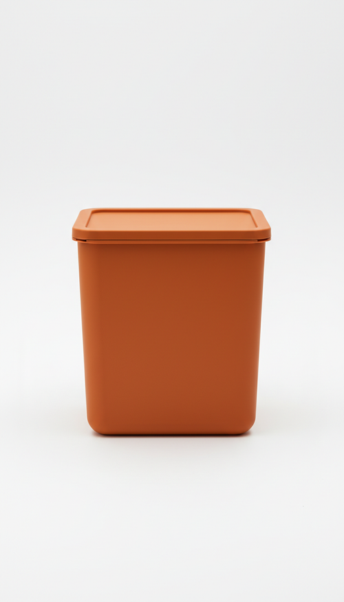A compact storage bin in Sunset Orange, the image is framed straight-on to emphasize elegance and clarity. No logos, no...